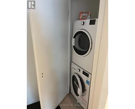 A white washing machine in a small room.