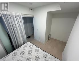 A bedroom with a bed and a window with curtains.