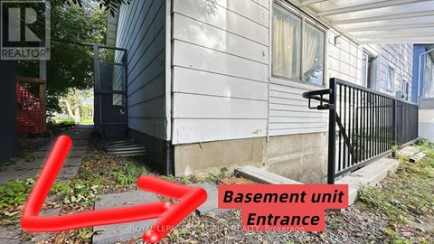 A basement unit entrance is shown with a red arrow pointing to it.