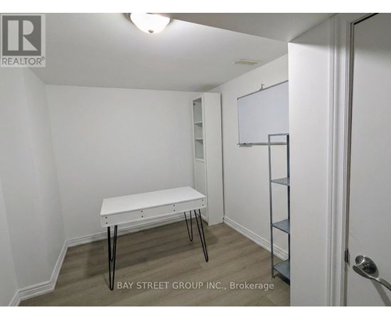 A white table with black legs in a white room.