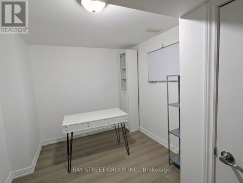 A white table with black legs in a white room.