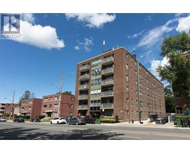 A large brick building with a balcony on the second floor.