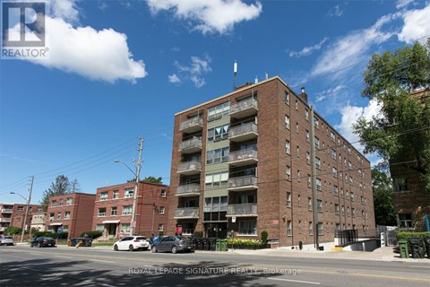 A large brick building with a balcony on the second floor.
