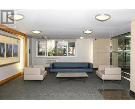 A well-lit waiting room with a couch, armchairs, and a coffee table.