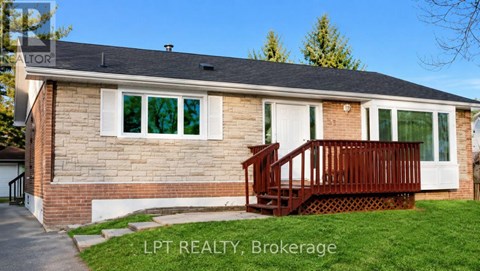 A house with a brown deck in front of it.