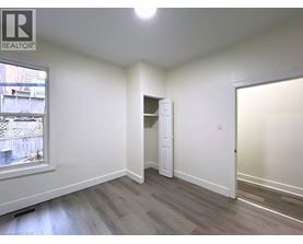 A room with a window and a door is available for rent.