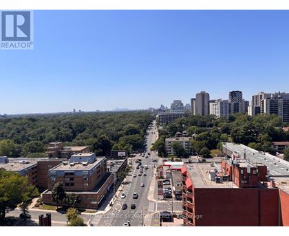 A city street with cars and buildings.