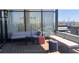 A modern outdoor seating area with a view of the city skyline.