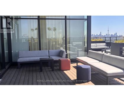A modern outdoor seating area with a view of the city skyline.