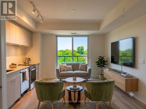 A well-lit, modern kitchen and living room with a view of the outdoors.