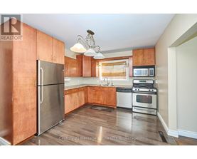 A kitchen with wooden cabinets and stainless steel appliances.
