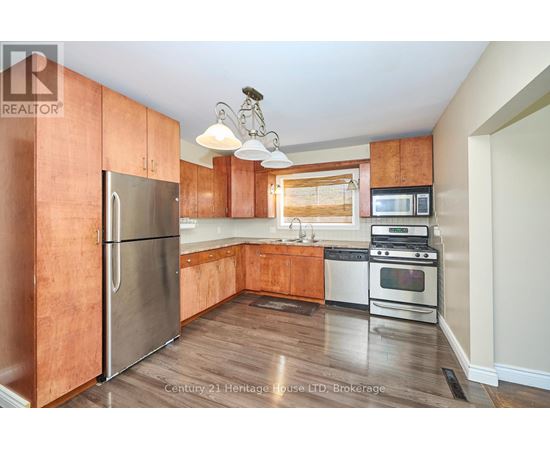 A kitchen with wooden cabinets and stainless steel appliances.