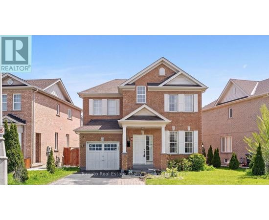 A large brick house with a white garage door in front.