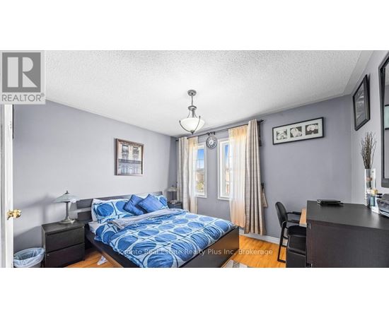 A bedroom with a bed, nightstand, and chair.