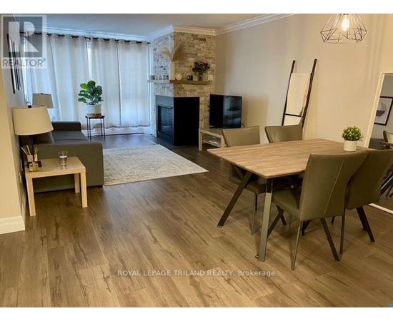 A living room with a fireplace and a dining table.