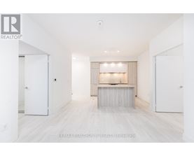 A spacious, empty room with a long table and a window with blinds.
