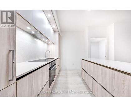 A modern kitchen with wooden cabinets and a large island.