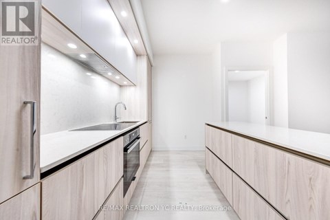 A modern kitchen with wooden cabinets and a large island.