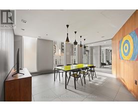 A modern dining room with a wooden table and chairs.