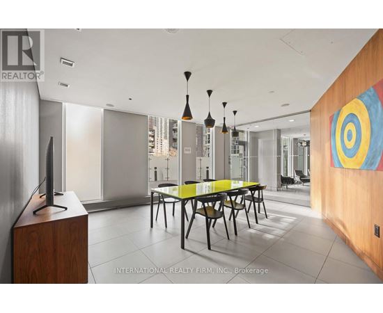 A modern dining room with a wooden table and chairs.