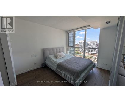 A bedroom with a large bed and a view of the city.