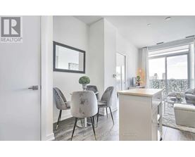 A modern dining room with a table set for four.