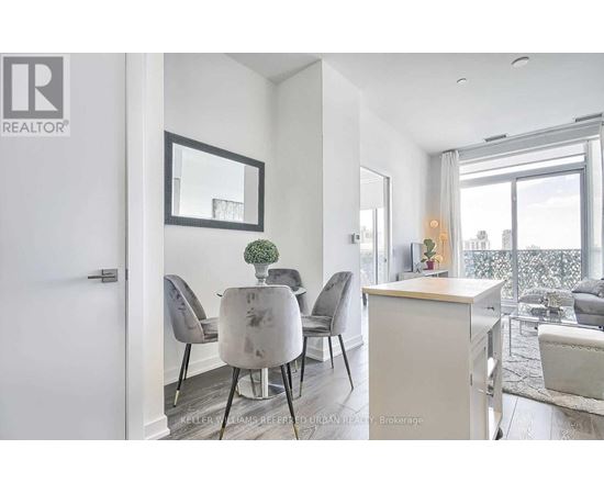 A modern dining room with a table set for four.