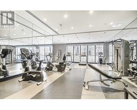 A gym with a variety of equipment including treadmills, weights, and exercise machines.