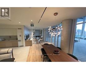 A modern dining area with a wooden table and chairs.