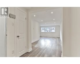 A spacious room with a door and a window.