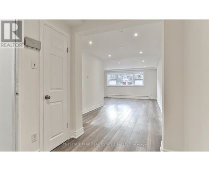 A spacious room with a door and a window.