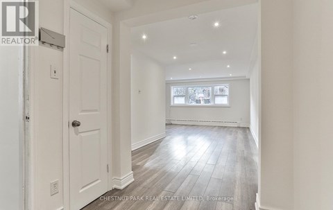 A spacious room with a door and a window.