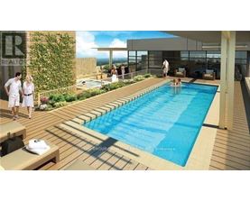 A pool surrounded by a wooden deck with people standing around it.