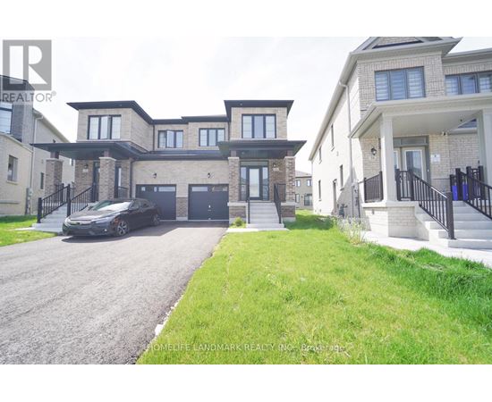 A realtor photo of a home with a black car parked in front.