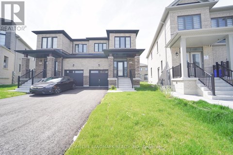 A realtor photo of a home with a black car parked in front.