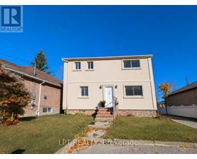 A house with a white door and windows is for sale.