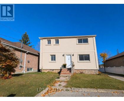 A house with a white door and windows is for sale.