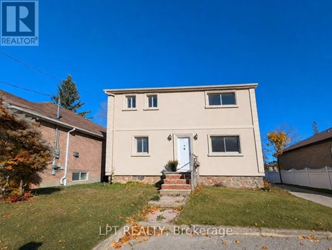 A house with a white door and windows is for sale.