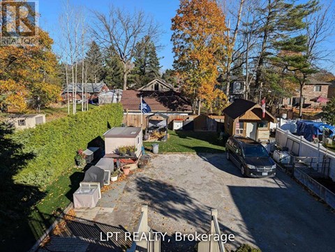 A residential area with houses and trees in autumn colors.