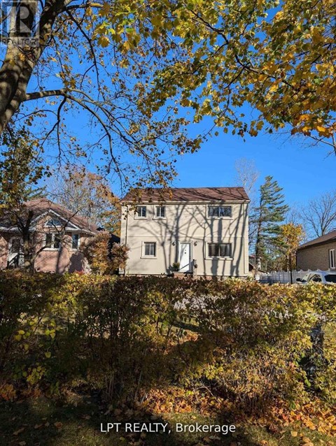 A house with a tree in front of it.