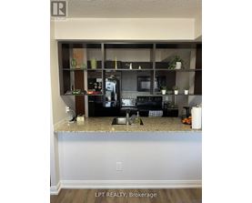A kitchen with granite countertops and a microwave.