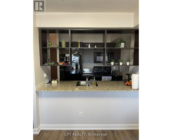 A kitchen with granite countertops and a microwave.