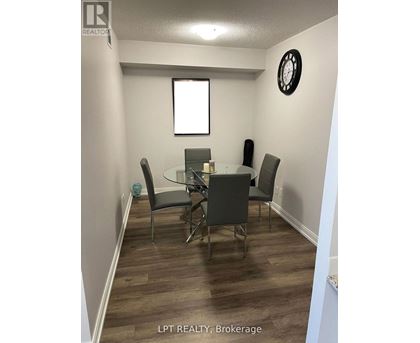 A dining room with a glass table and chairs.