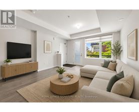 A living room with a flat screen TV, a coffee table, and a couch.