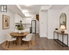 A dining room with a round table and chairs.