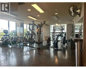 A gym with a variety of equipment including treadmills, weights, and exercise machines.