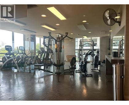 A gym with a variety of equipment including treadmills, weights, and exercise machines.