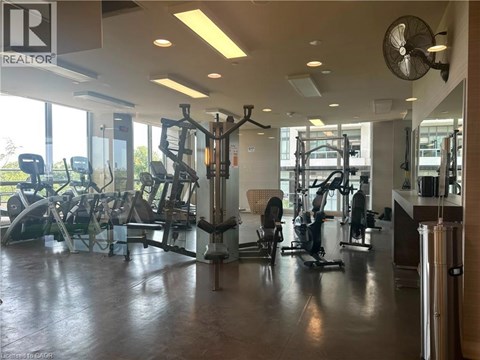 A gym with a variety of equipment including treadmills, weights, and exercise machines.