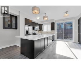A modern kitchen with a large island and stainless steel appliances.