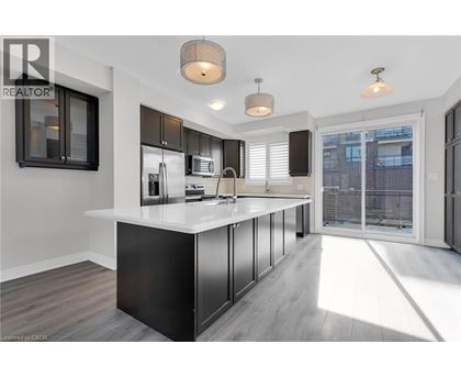 A modern kitchen with a large island and stainless steel appliances.